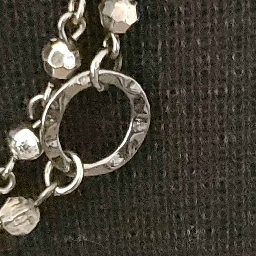 Silvertone and black bead and geometric stations necklace